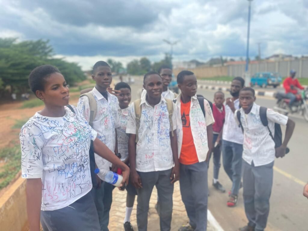 Secondary school students sign out on uniforms after completing WAEC