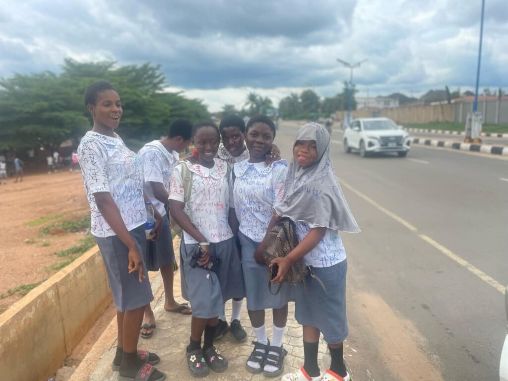 Secondary school students sign out on uniforms after completing WAEC