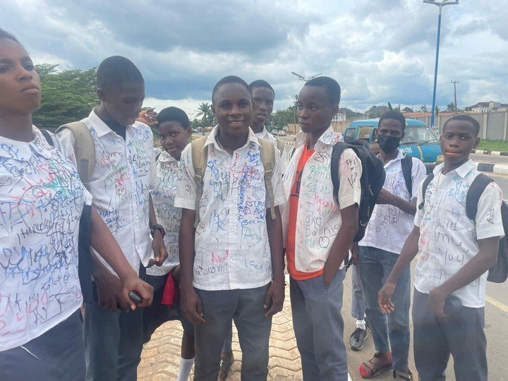 Secondary school students sign out on uniforms after completing WAEC