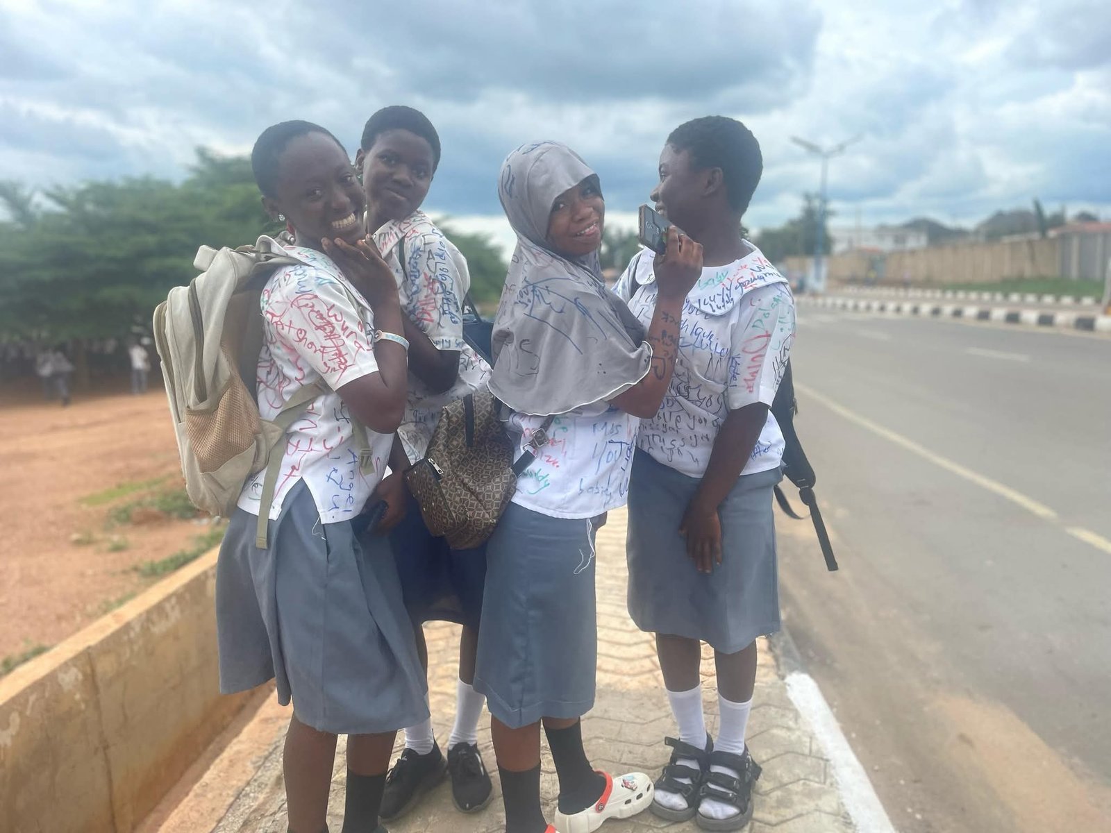 Secondary school students sign out on uniforms after completing WAEC